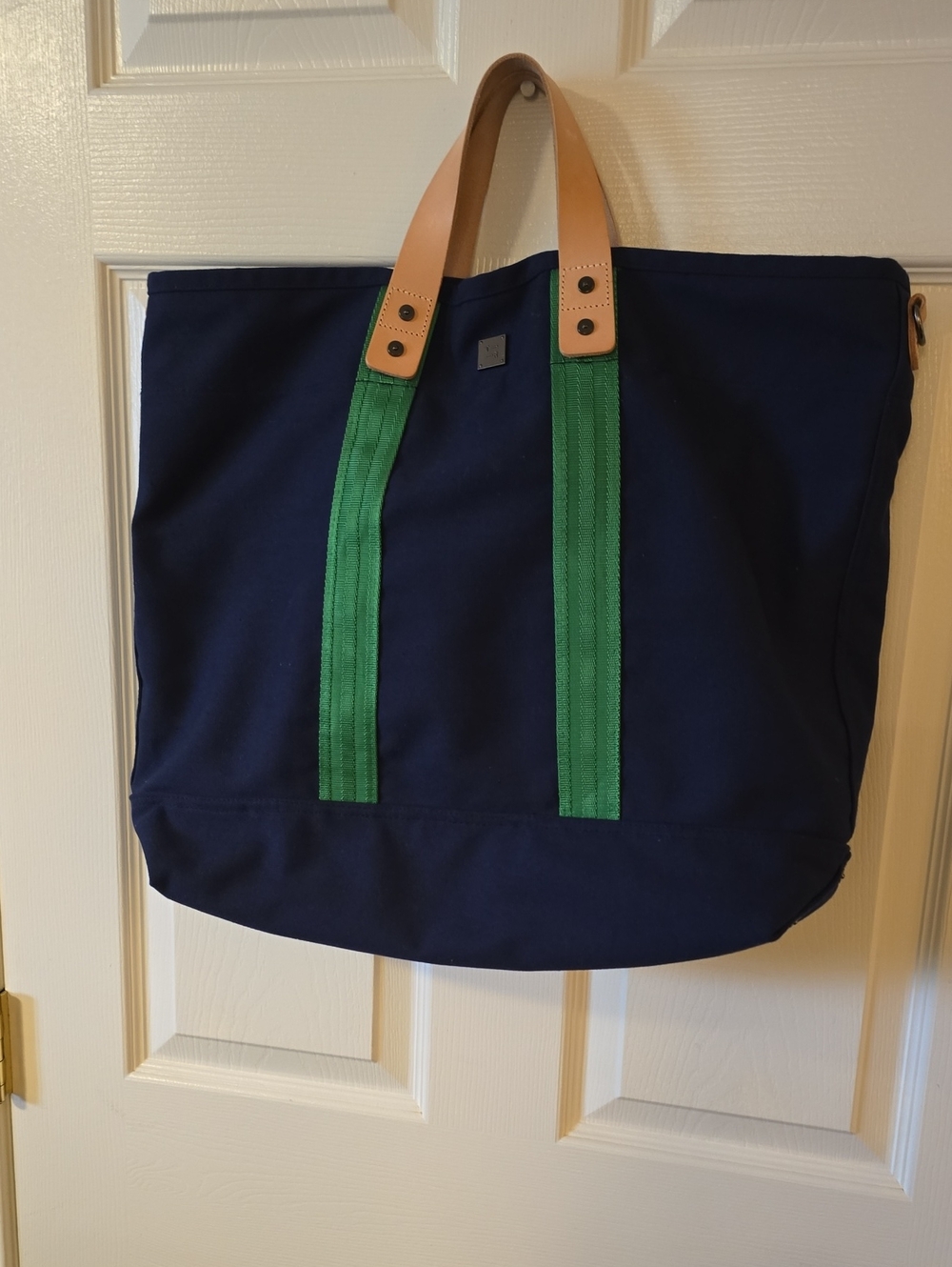 Navy Canvas Tote Bag with Green Straps and Tan Handles. Think Royln Brand.
